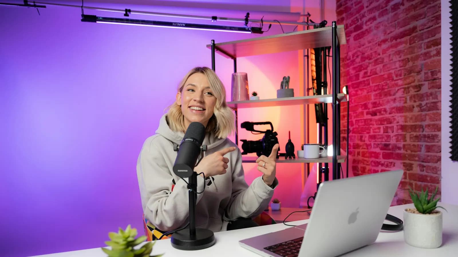 Criadora produzindo um podcast com notebook e microfone